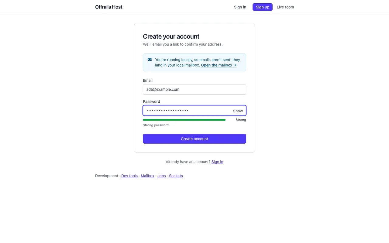 The sign-up form: an email address, a password with a Show button and a strength meter reading Strong, a Create account button, and a note that emails land in the local mailbox in development.
